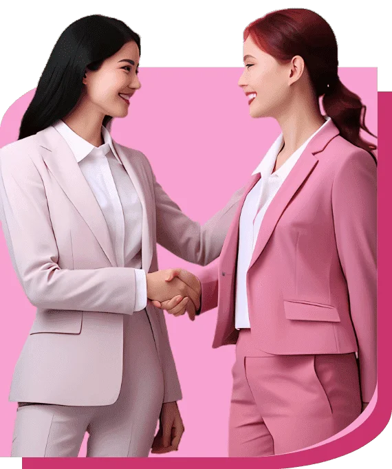 Two businesswomen in suits greeting each other with a handshake.