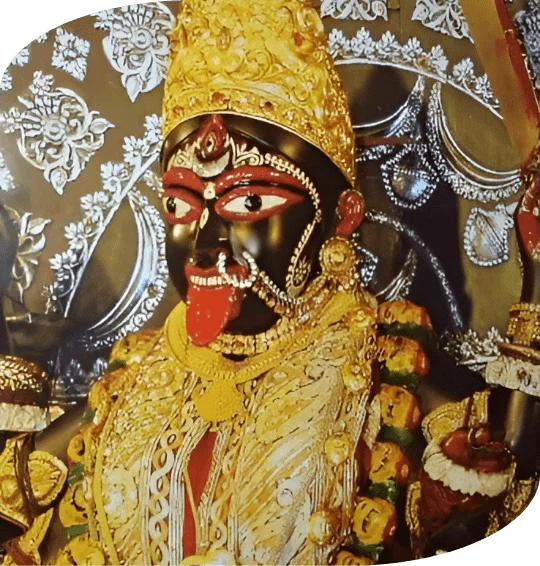 A statue of Dakshineshwari Kali Maa with gold and red decorations, representing divine beauty and cultural richness.